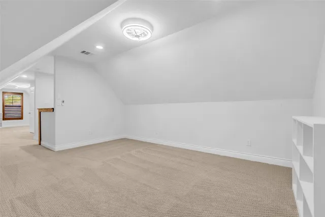 an empty room with a bench and a window