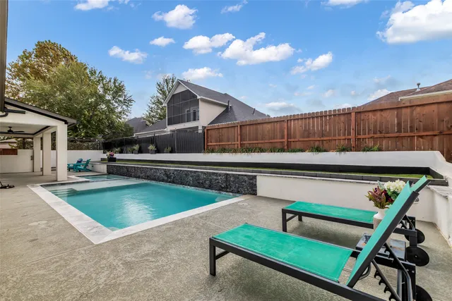 a view of a chairs and tables in the back yard of the house