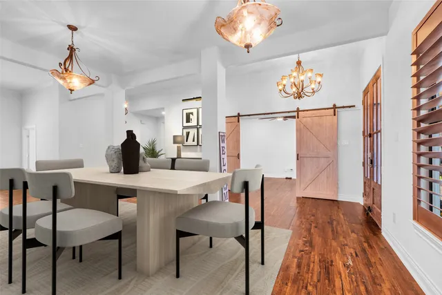 a view of a dining room with furniture wooden floor and a chandelier