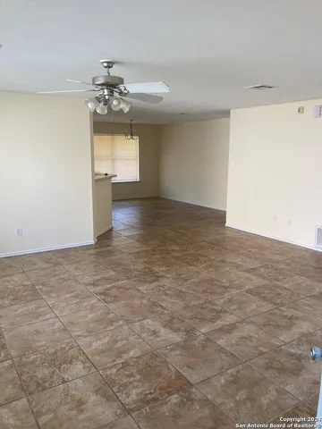 a view of a kitchen with a sink and chandelier