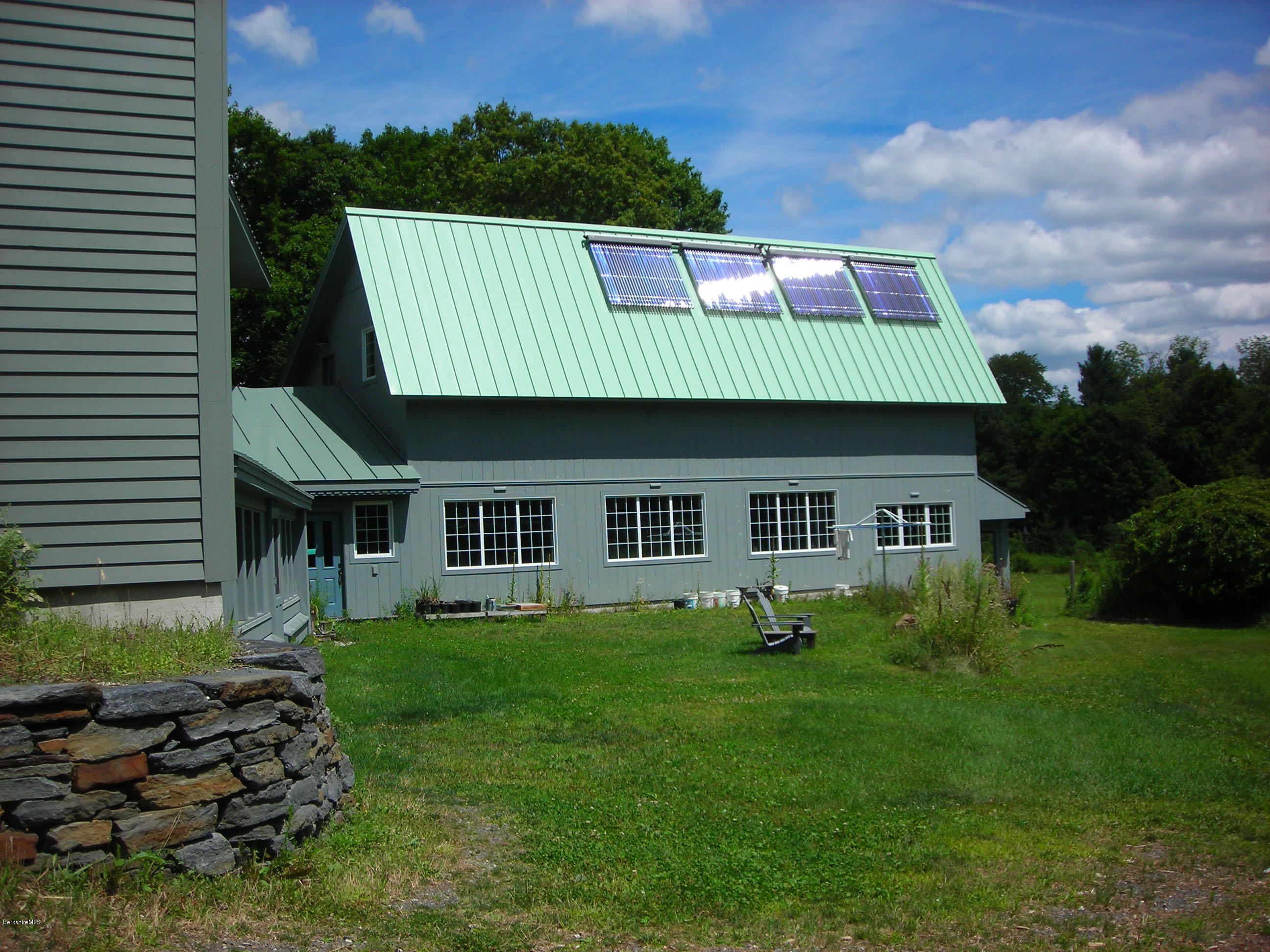 945 State Road Richmond, MA 01254 - Photo 4 of 32 a front view of a house with a garden