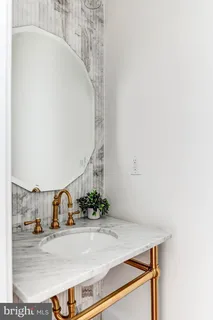 a bedroom with a bed and a large mirror next to a window