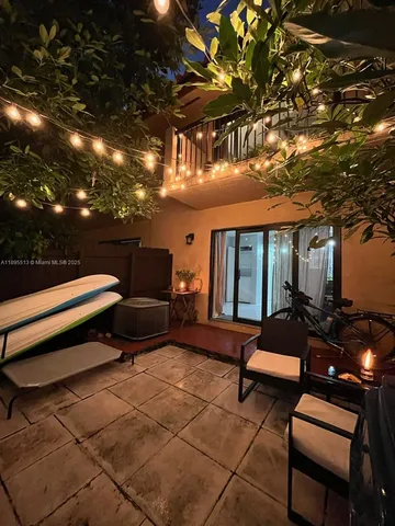 a roof deck with couches and potted plants