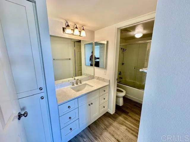 a bathroom with a double vanity sink and mirror with shower
