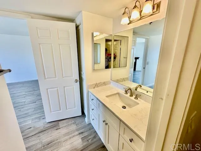 a bathroom with a double vanity sink and mirror