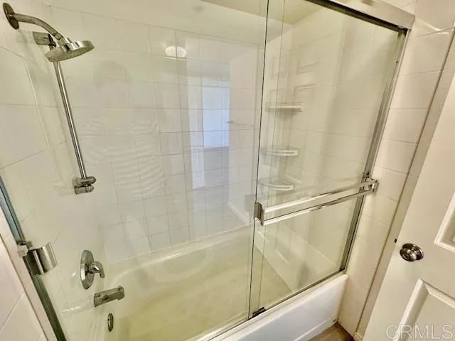 a bathroom with a shower and a tub