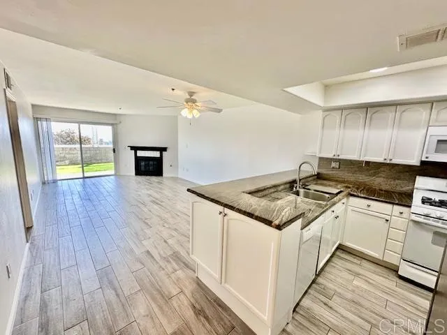 a kitchen with a stove and a wooden floors