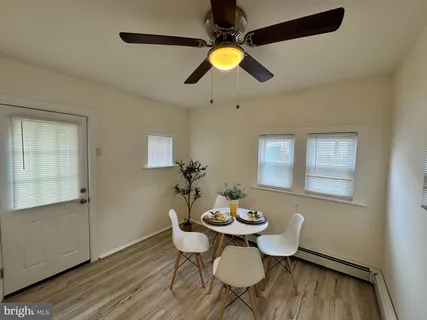a view of a dining room with furniture and wooden floor