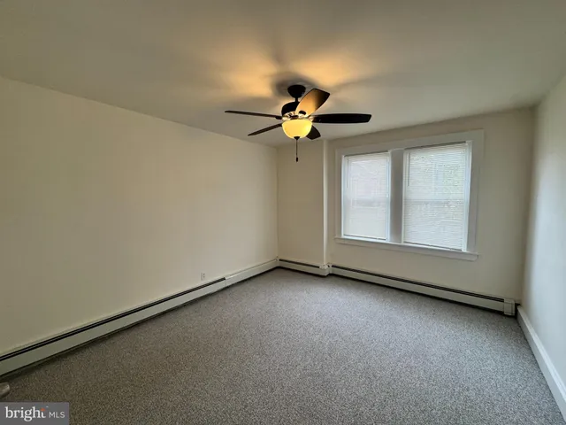 a view of room with ceiling fan and window
