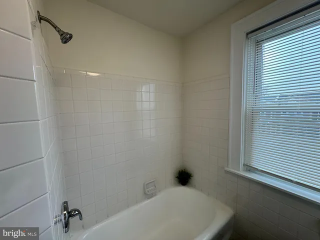 a bathroom with a bathtub and shower