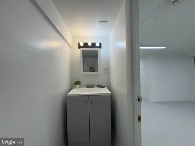 a bathroom with a sink and mirror