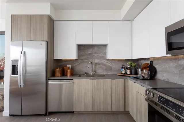 a kitchen with cabinets and stainless steel appliances