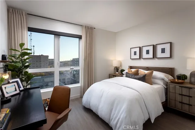 a bed sitting in a bedroom next to a window