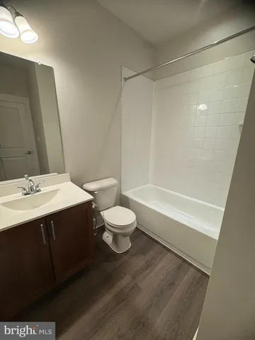 a bathroom with a sink a toilet and a large mirror