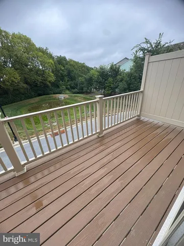 a view of balcony with wooden floor and fence