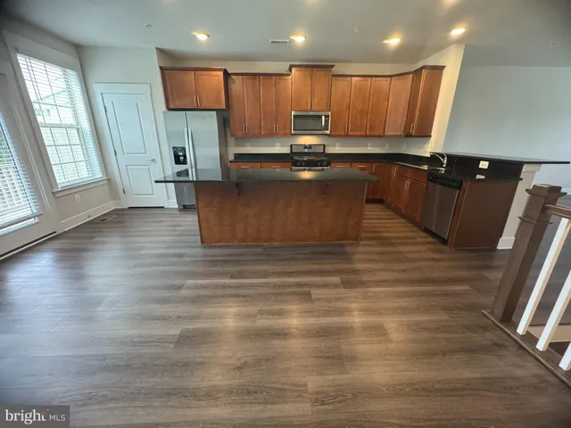 a view of kitchen with wooden floor