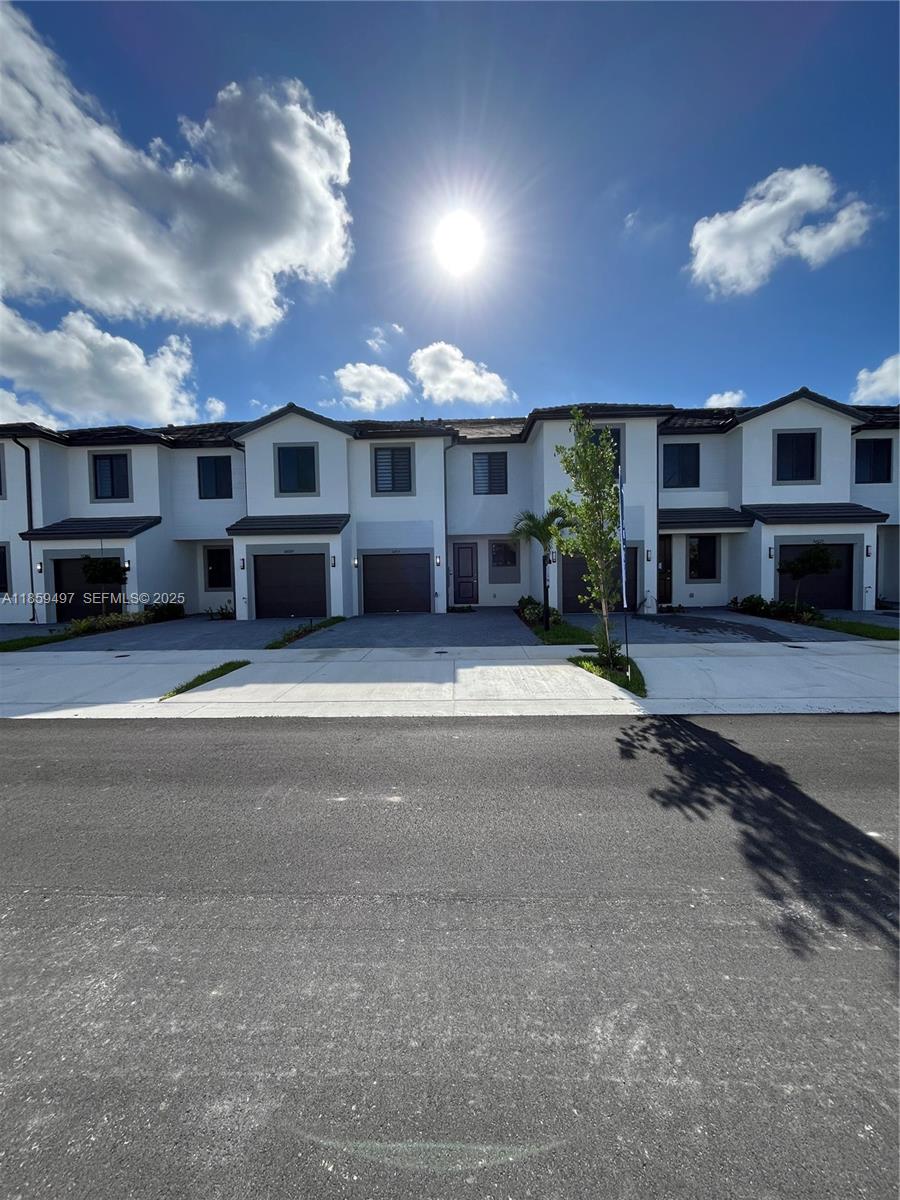 a view of a house with a flat tv screen and a kitchen view