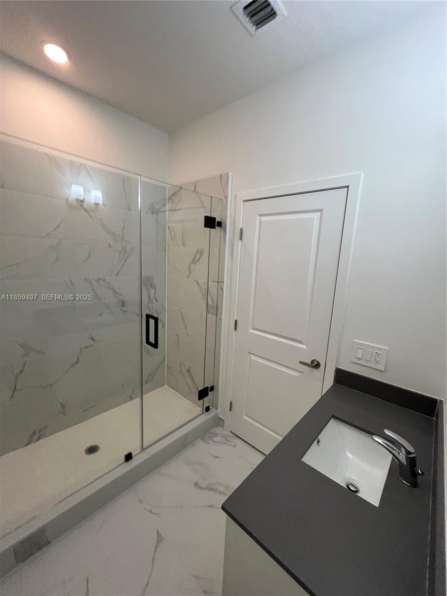 34515 Southwest 191st Court Homestead, FL 33034 - Photo 16 of 25 a bathroom with a shower and a sink