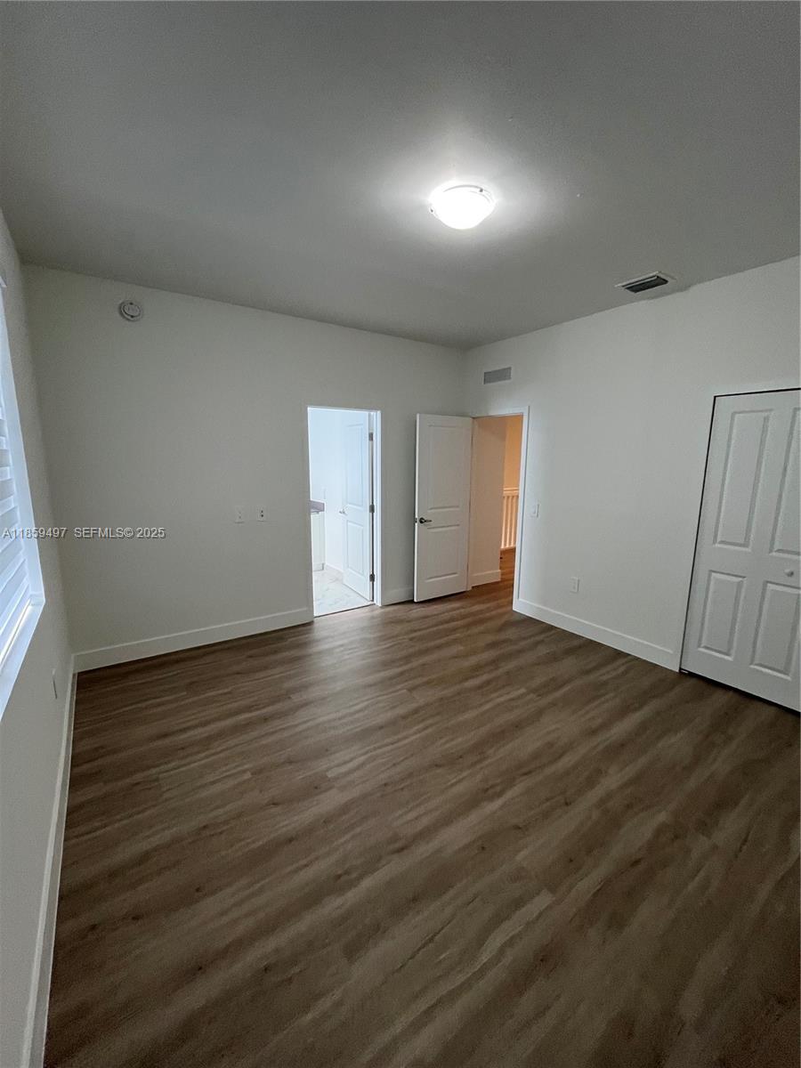 34515 Southwest 191st Court Homestead, FL 33034 - Photo 23 of 25 a view of an empty room with wooden floor and a window