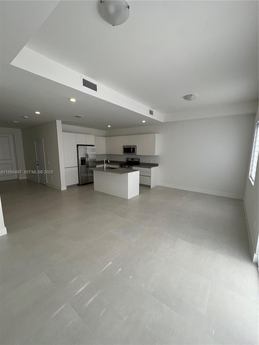 34515 Southwest 191st Court Homestead, FL 33034 - Photo 6 of 25 a view of a kitchen with a sink and a refrigerator