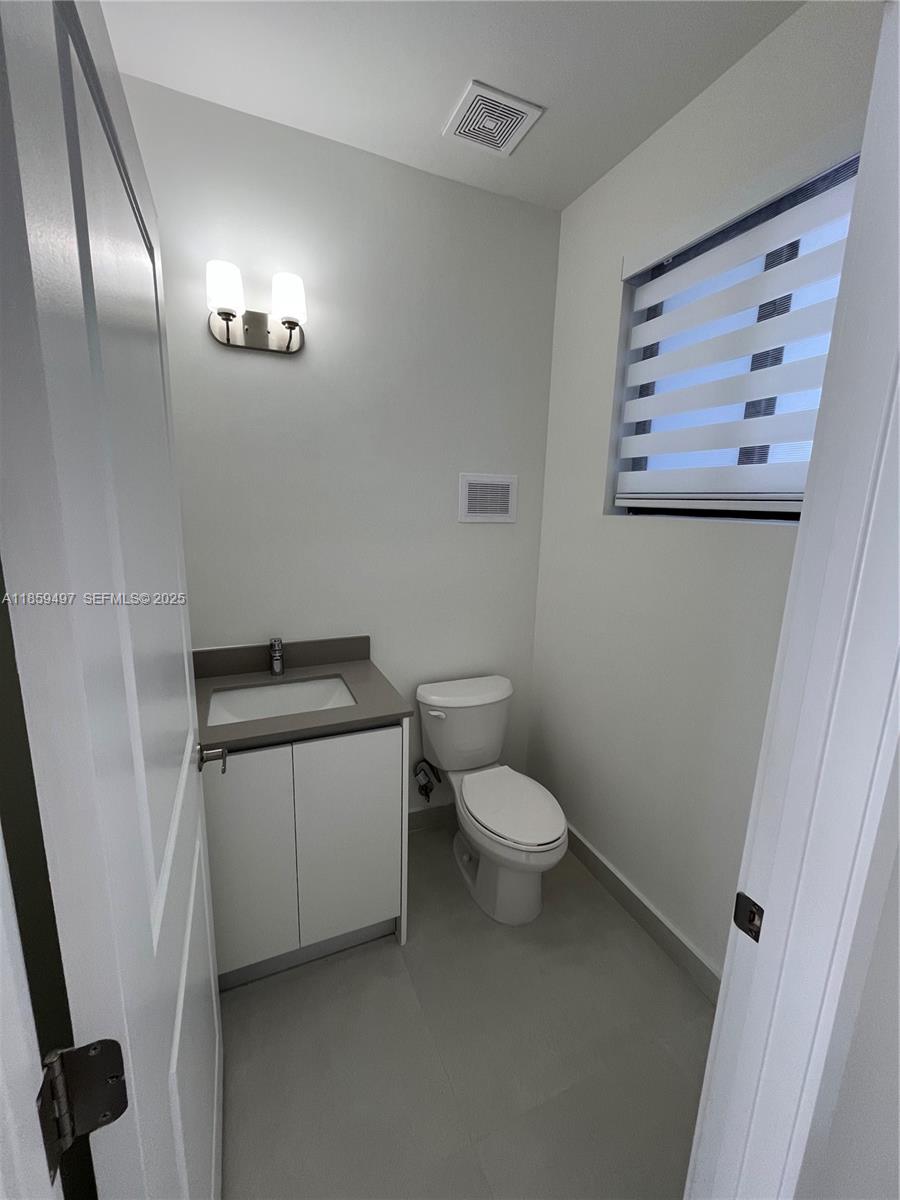 34515 Southwest 191st Court Homestead, FL 33034 - Photo 7 of 25 a bathroom with a toilet sink and vanity