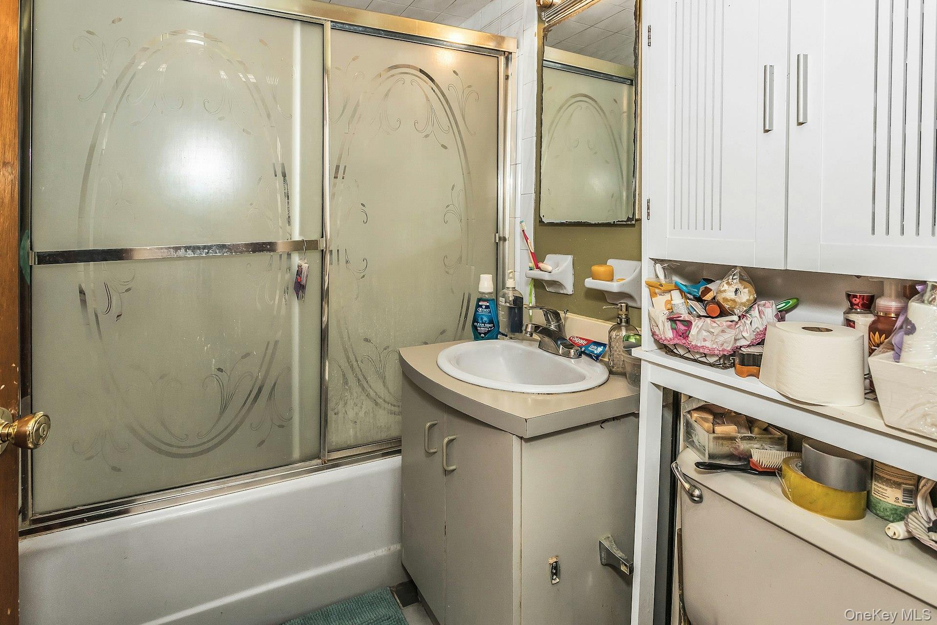 54-09 108th Street, Unit 1C Queens, NY 11368 - Photo 12 of 15 a bathroom with a sink a toilet and shower