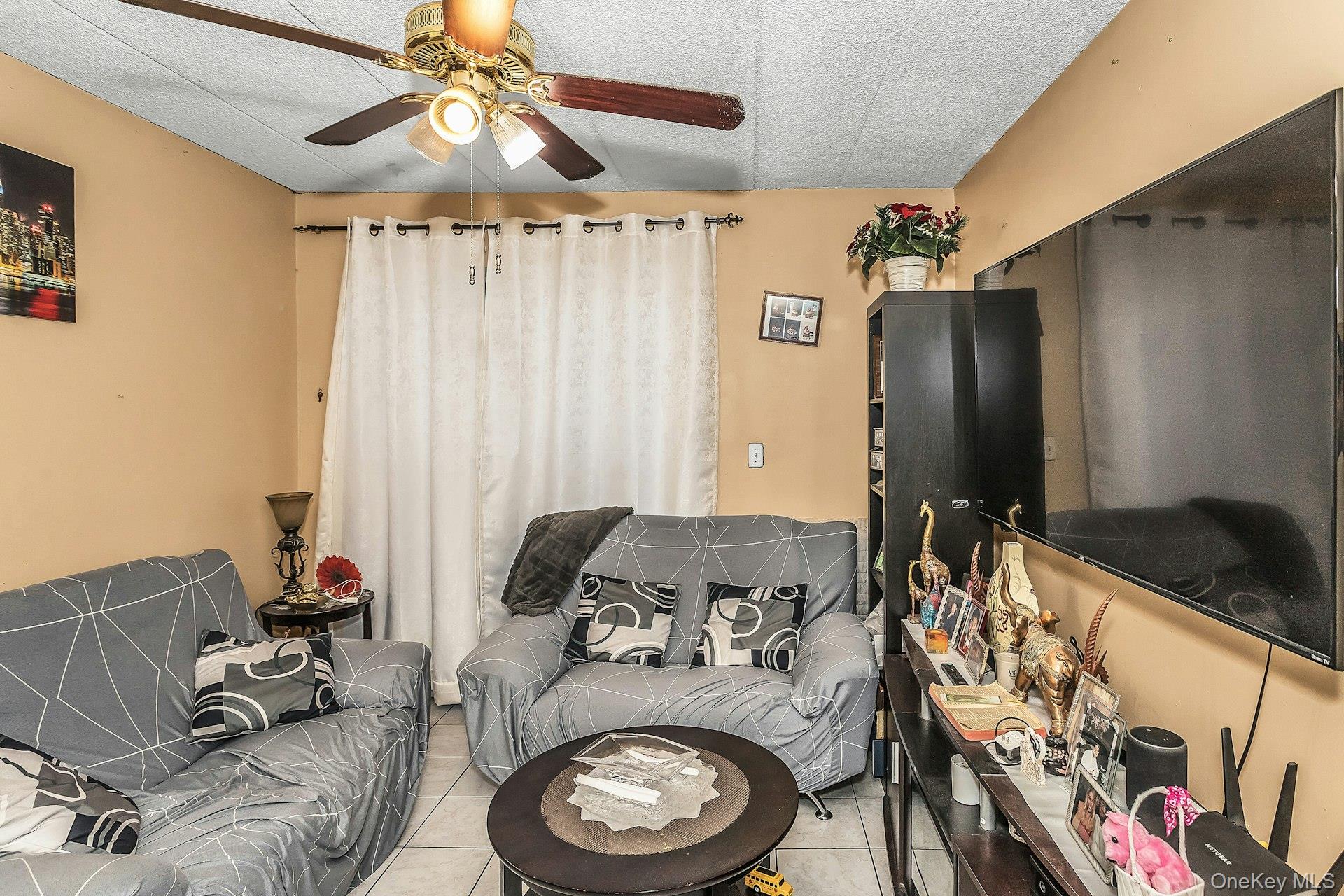 54-09 108th Street, Unit 1C Queens, NY 11368 - Photo 3 of 15 a bed room with a bed and a fish tank