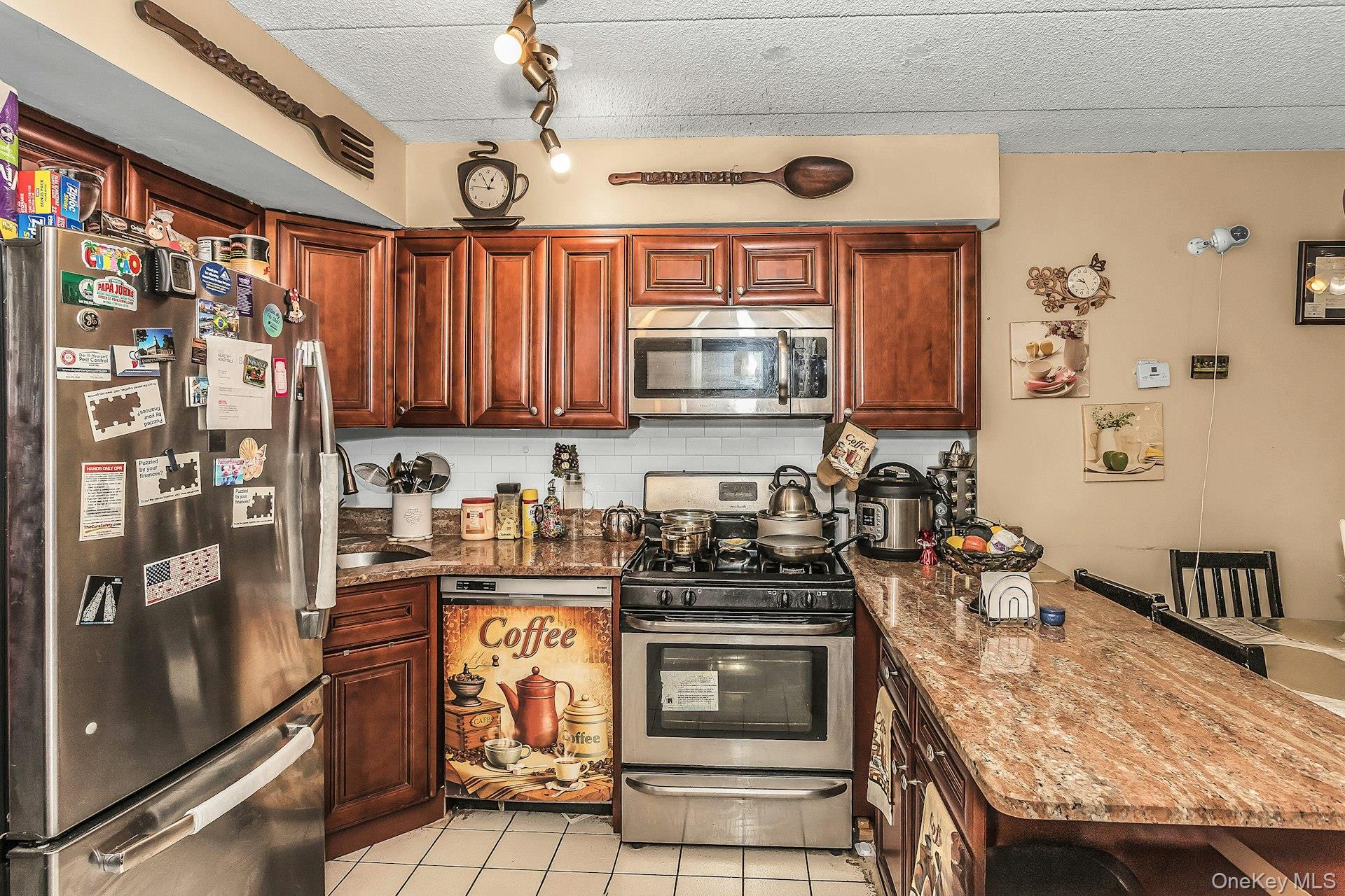 54-09 108th Street, Unit 1C Queens, NY 11368 - Photo 6 of 15 a kitchen with stainless steel appliances granite countertop a stove a sink dishwasher and cabinets with wooden floor