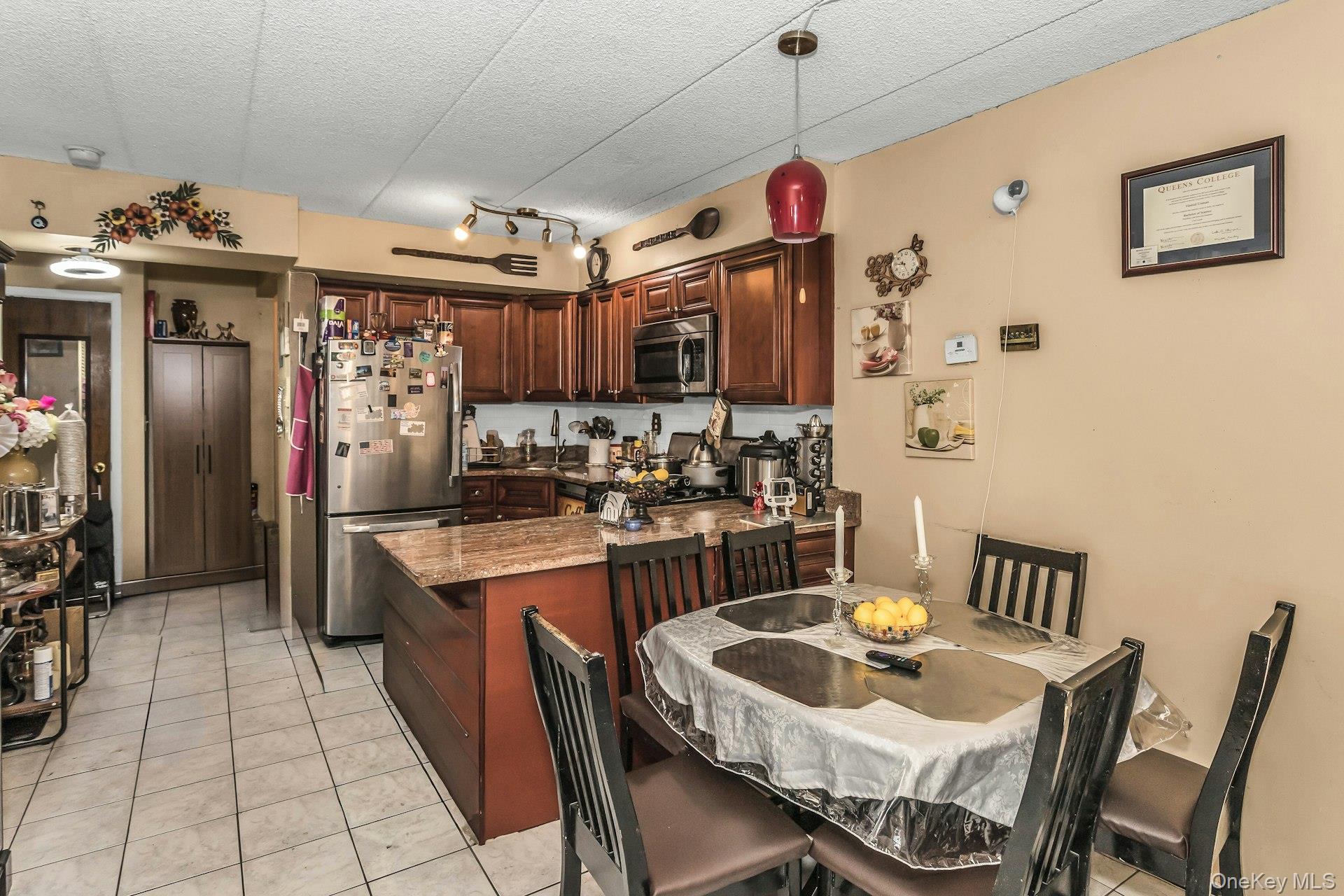 54-09 108th Street, Unit 1C Queens, NY 11368 - Photo 9 of 15 a kitchen with stainless steel appliances granite countertop a sink a stove and a refrigerator