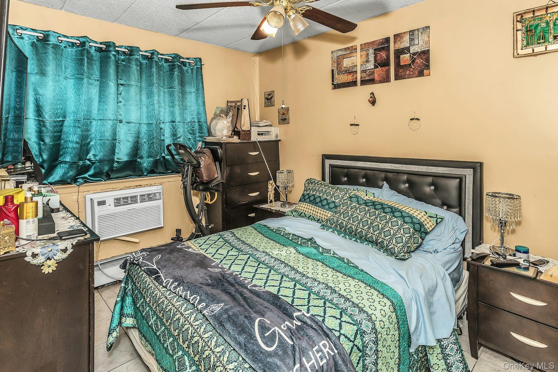 54-09 108th Street, Unit 1C Queens, NY 11368 - Photo 10 of 15 a bedroom with a bed and a dresser