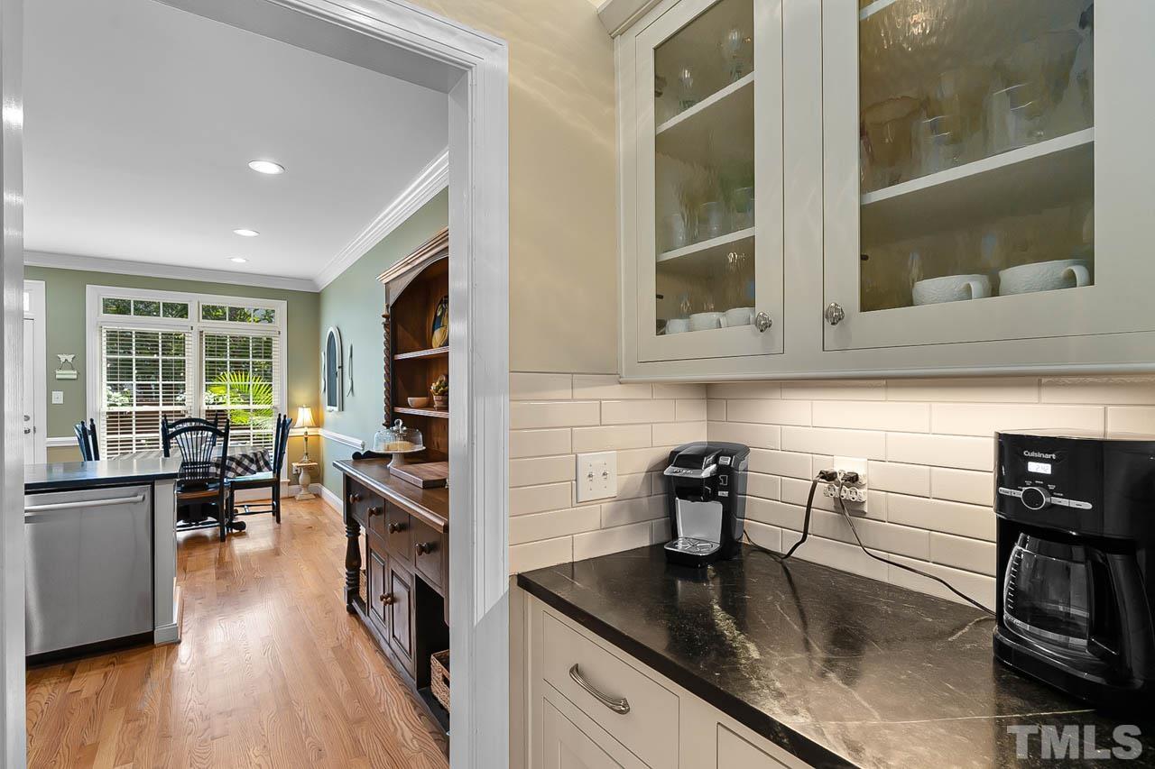 3500 Proprietor Way Raleigh, NC 27612 - Photo 18 of 47 a kitchen with granite countertop a stove and a wooden floor
