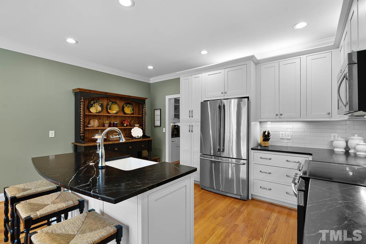 3500 Proprietor Way Raleigh, NC 27612 - Photo 21 of 47 a kitchen with stainless steel appliances granite countertop a refrigerator and a stove top oven