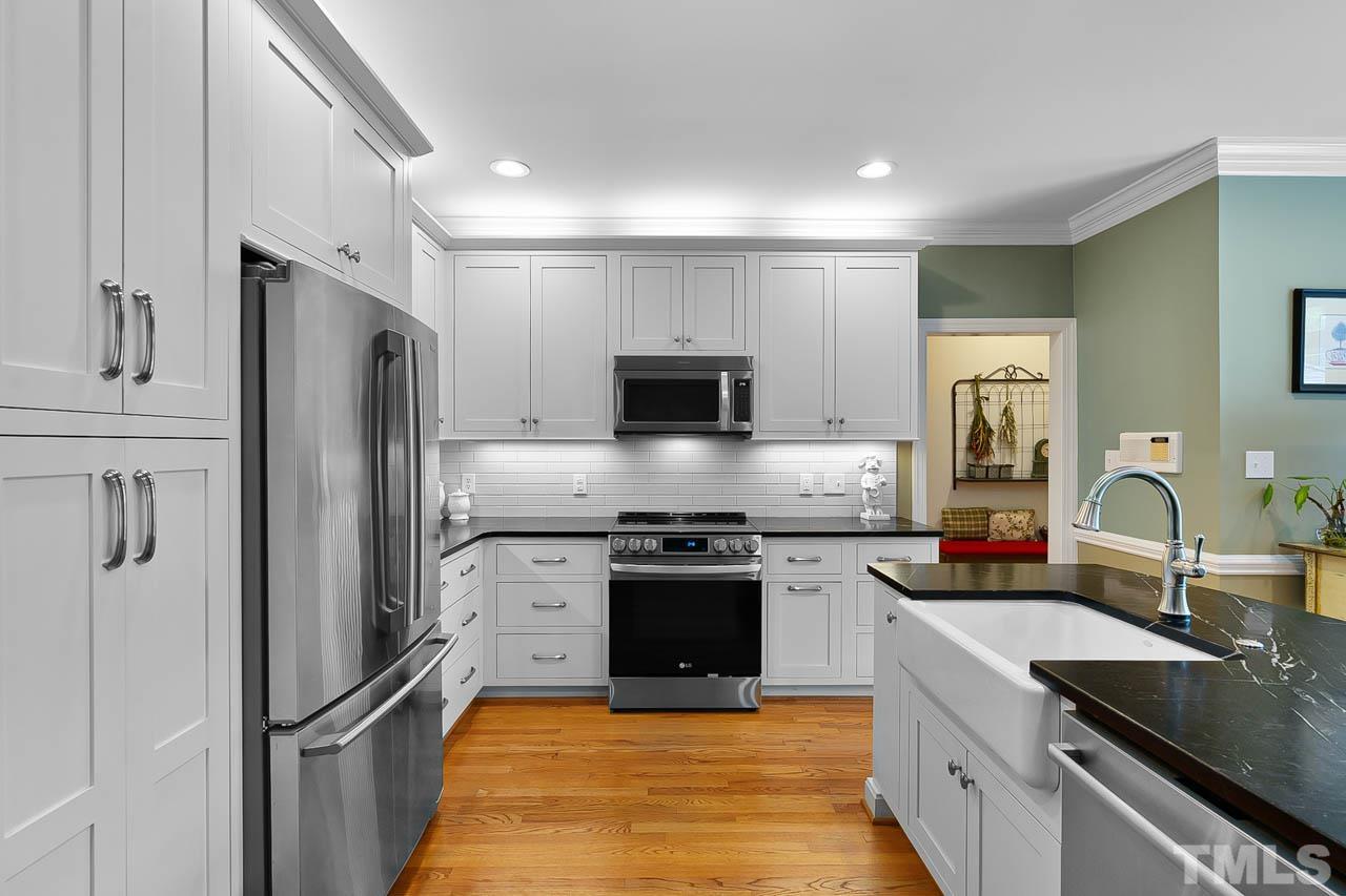 3500 Proprietor Way Raleigh, NC 27612 - Photo 22 of 47 a kitchen with stainless steel appliances granite countertop a sink stove and refrigerator