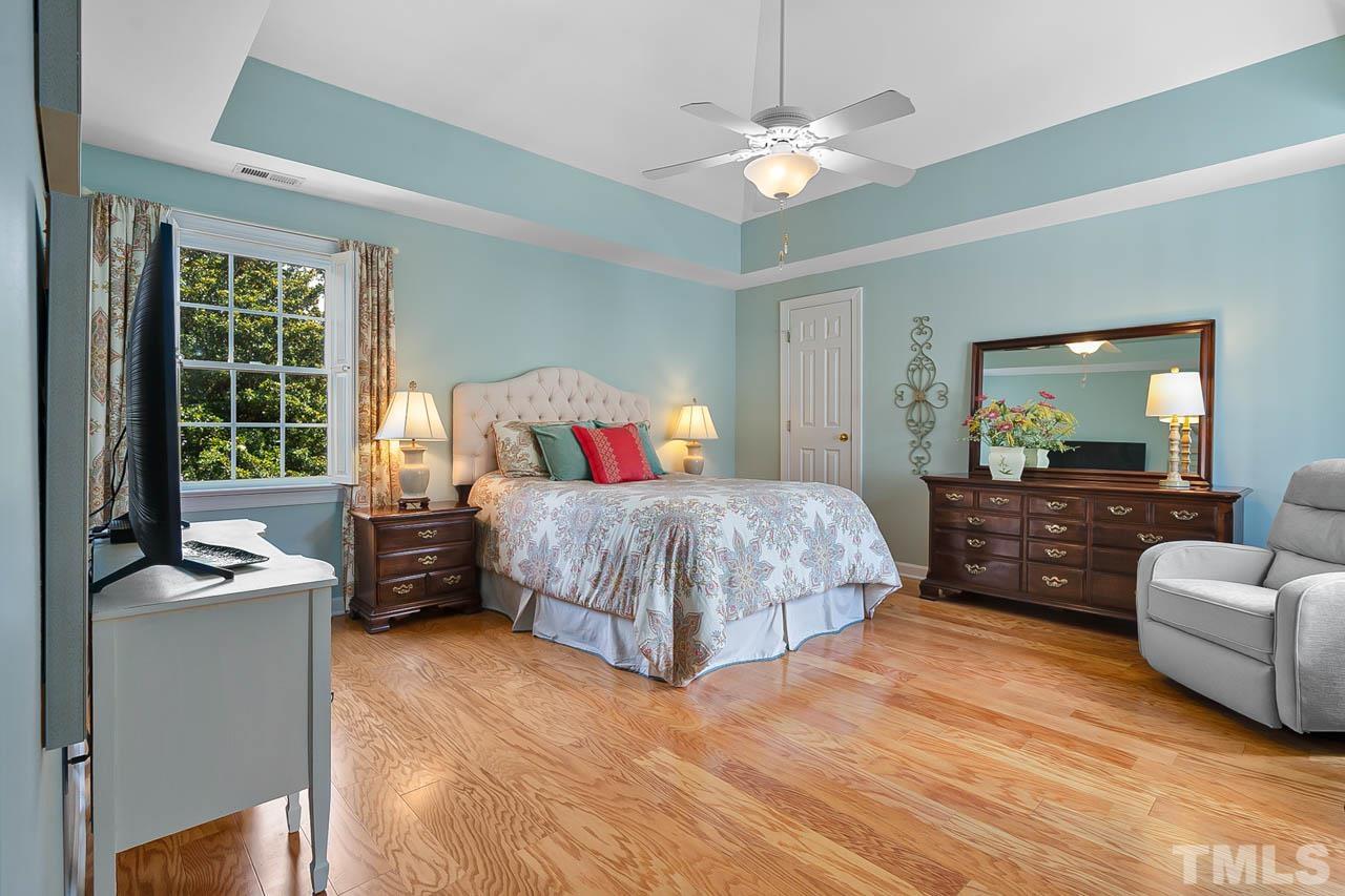 3500 Proprietor Way Raleigh, NC 27612 - Photo 28 of 47 a bedroom with a large bed and a chandelier