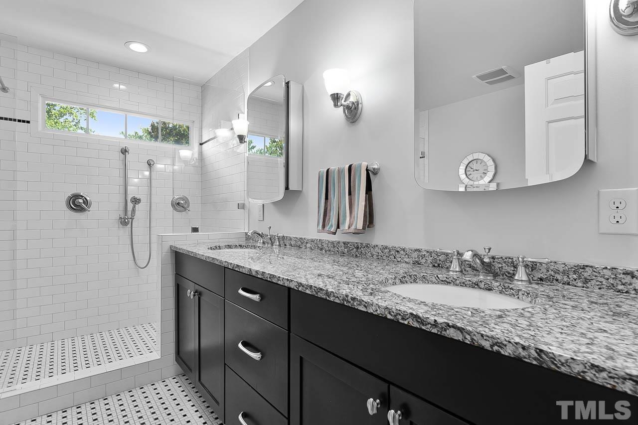 3500 Proprietor Way Raleigh, NC 27612 - Photo 31 of 47 a bathroom with a granite countertop sink a shower and a mirror