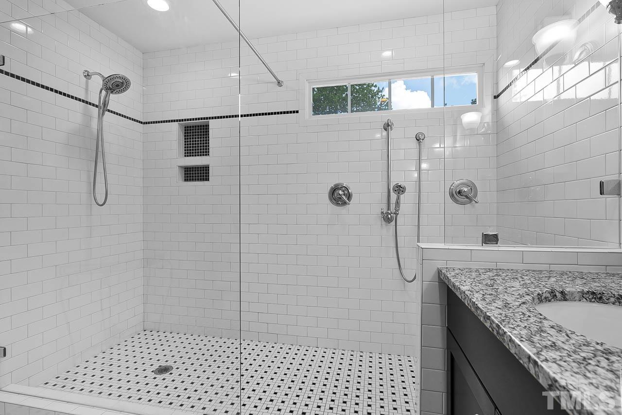 3500 Proprietor Way Raleigh, NC 27612 - Photo 32 of 47 a bathroom with a granite countertop shower a mirror and a sink
