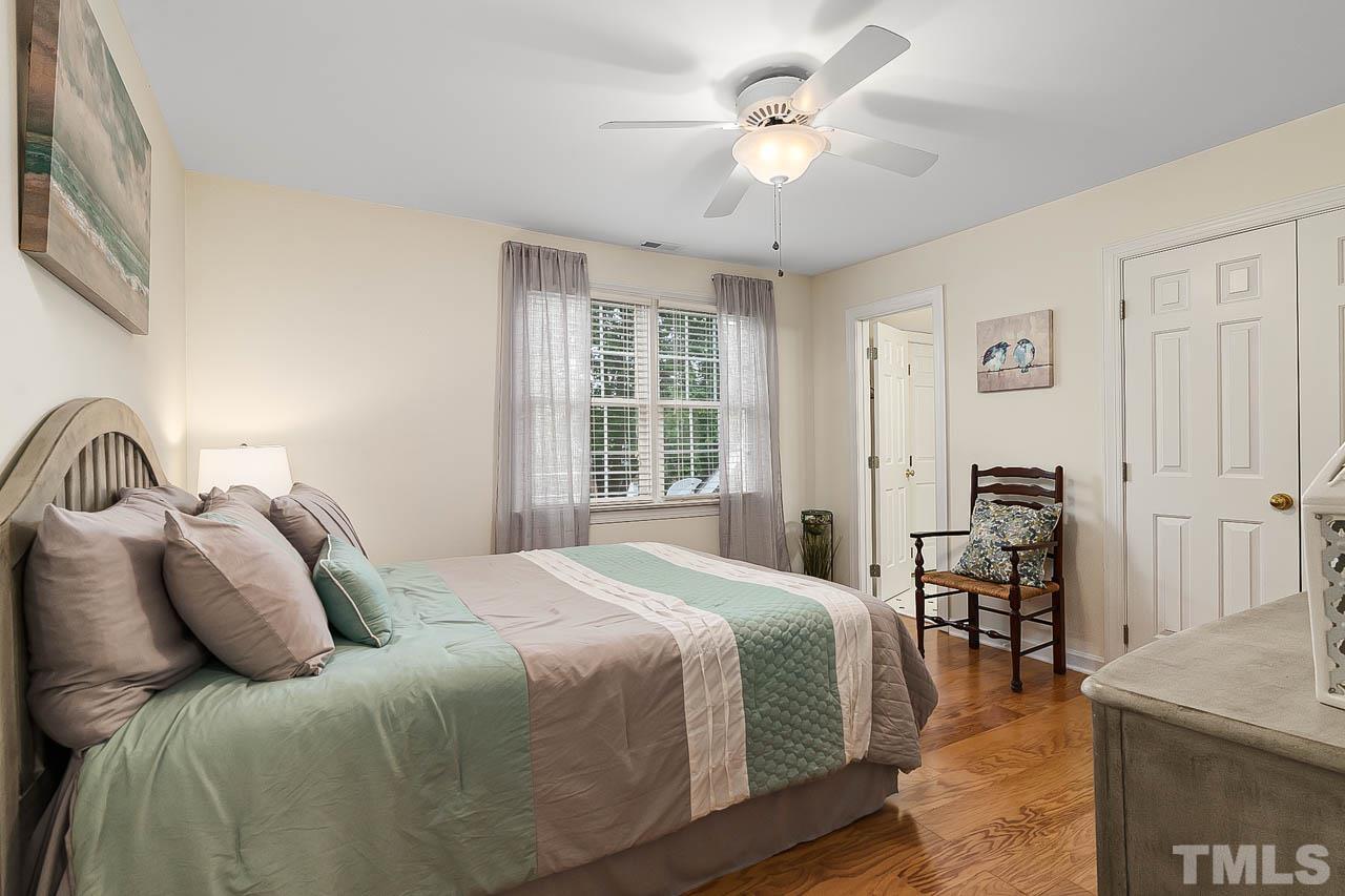 3500 Proprietor Way Raleigh, NC 27612 - Photo 35 of 47 a bedroom with a large bed and a chandelier