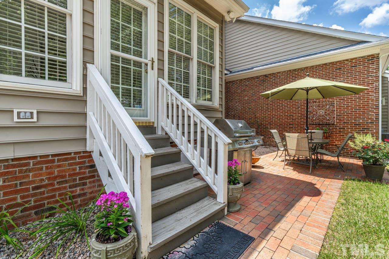 3500 Proprietor Way Raleigh, NC 27612 - Photo 42 of 47 a view of a patio with table and chairs under an umbrella