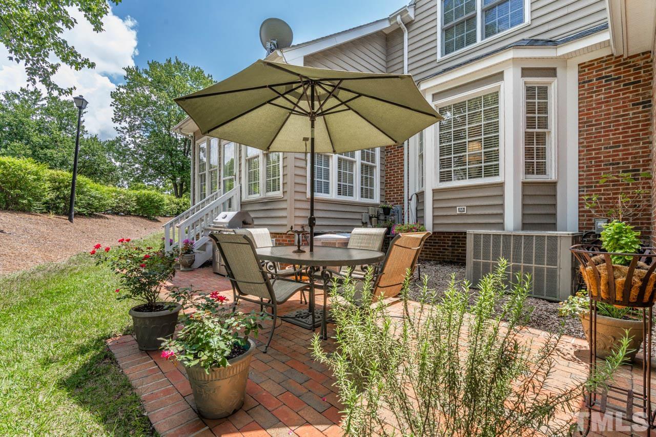 3500 Proprietor Way Raleigh, NC 27612 - Photo 44 of 47 a patio with a table and chairs under an umbrella