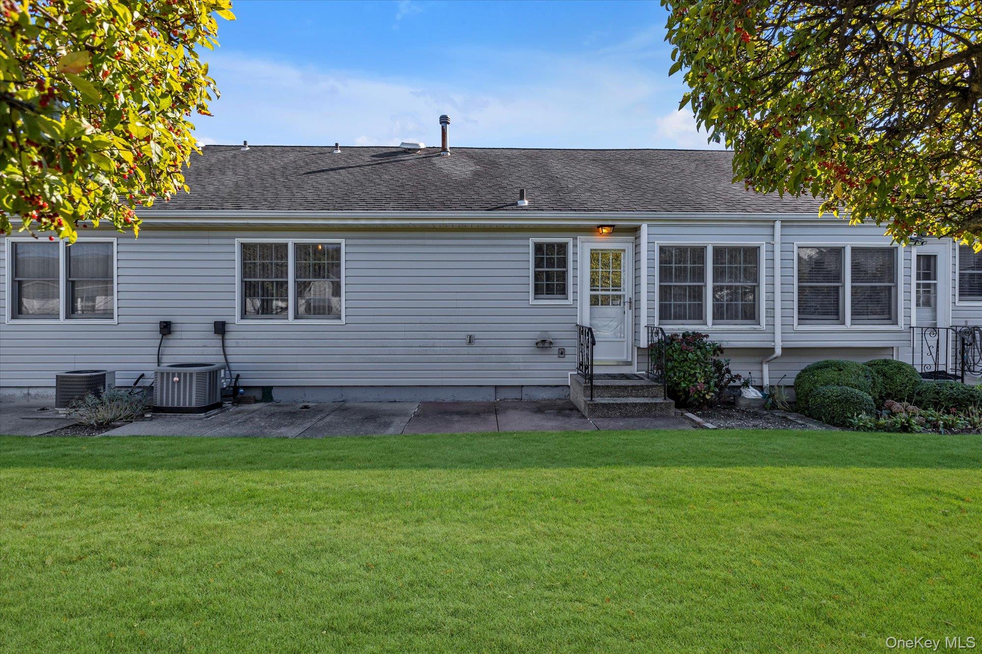 20 Primrose Lane North Babylon, NY 11703 - Photo 16 of 19 a view of a house with a yard and sitting area
