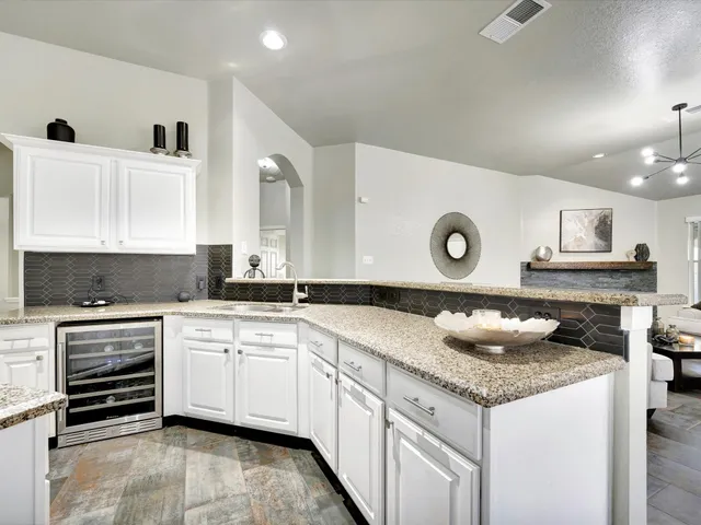 a kitchen with stainless steel appliances granite countertop a refrigerator stove and microwave