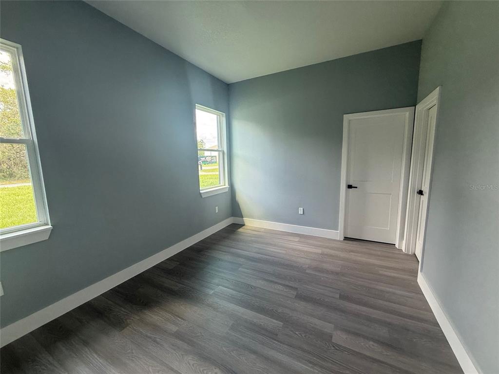 14919 Southwest 46th Circle Ocala, FL 34473 - Photo 11 of 22 a view of an empty room with wooden floor and a window