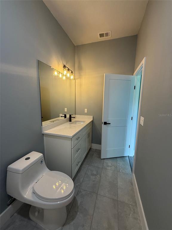 14919 Southwest 46th Circle Ocala, FL 34473 - Photo 12 of 22 a bathroom with a sink toilet and mirror