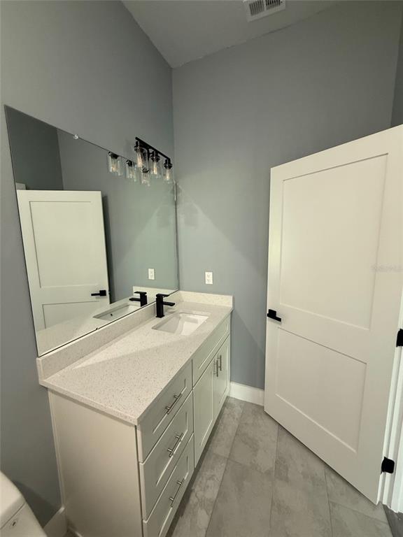 14919 Southwest 46th Circle Ocala, FL 34473 - Photo 16 of 22 a bathroom with a sink and mirror