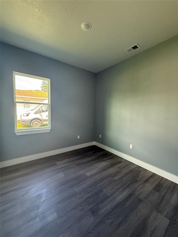 14919 Southwest 46th Circle Ocala, FL 34473 - Photo 17 of 22 an empty room with wooden floor and windows