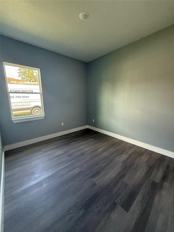 14919 Southwest 46th Circle Ocala, FL 34473 - Photo 18 of 22 an empty room with wooden floor and windows