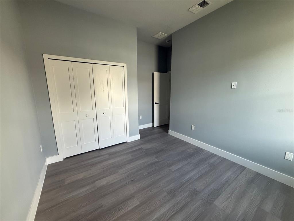 14919 Southwest 46th Circle Ocala, FL 34473 - Photo 19 of 22 a view of an empty room with wooden floor
