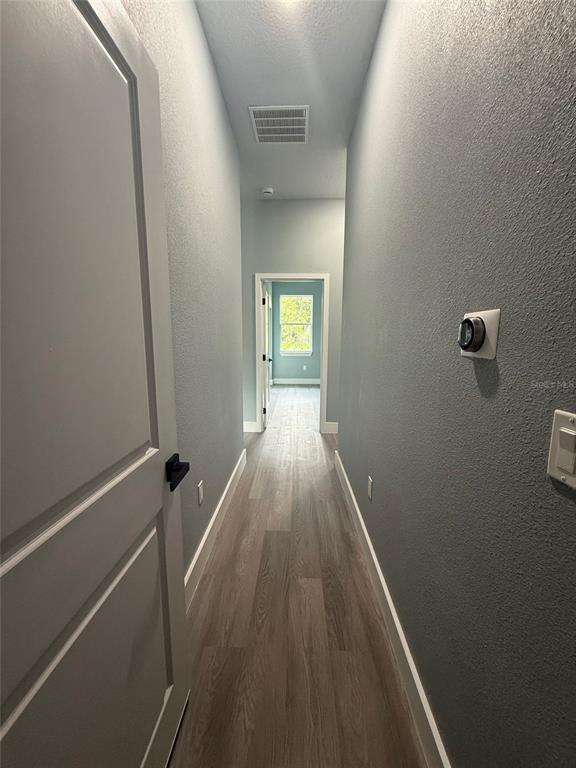 14919 Southwest 46th Circle Ocala, FL 34473 - Photo 8 of 22 a view of a hallway with wooden floor