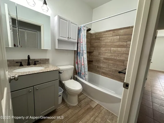 a bathroom with a sink toilet and shower