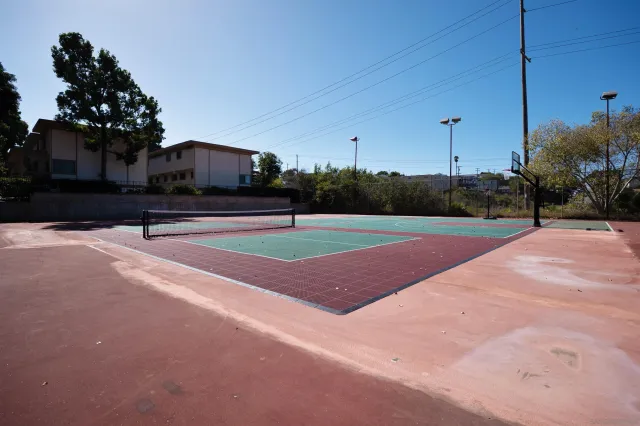 a hallway with wooden floor and chandelier